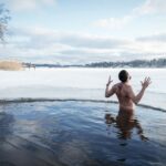 a man standing in a body of water